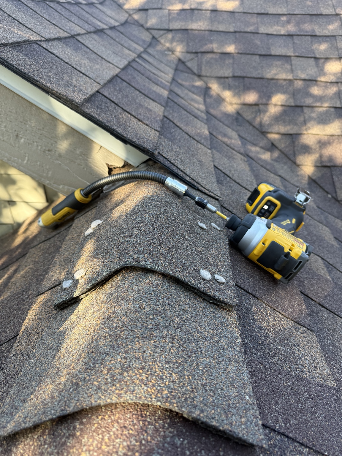 Technician installing protection at a vulnerable roof vent